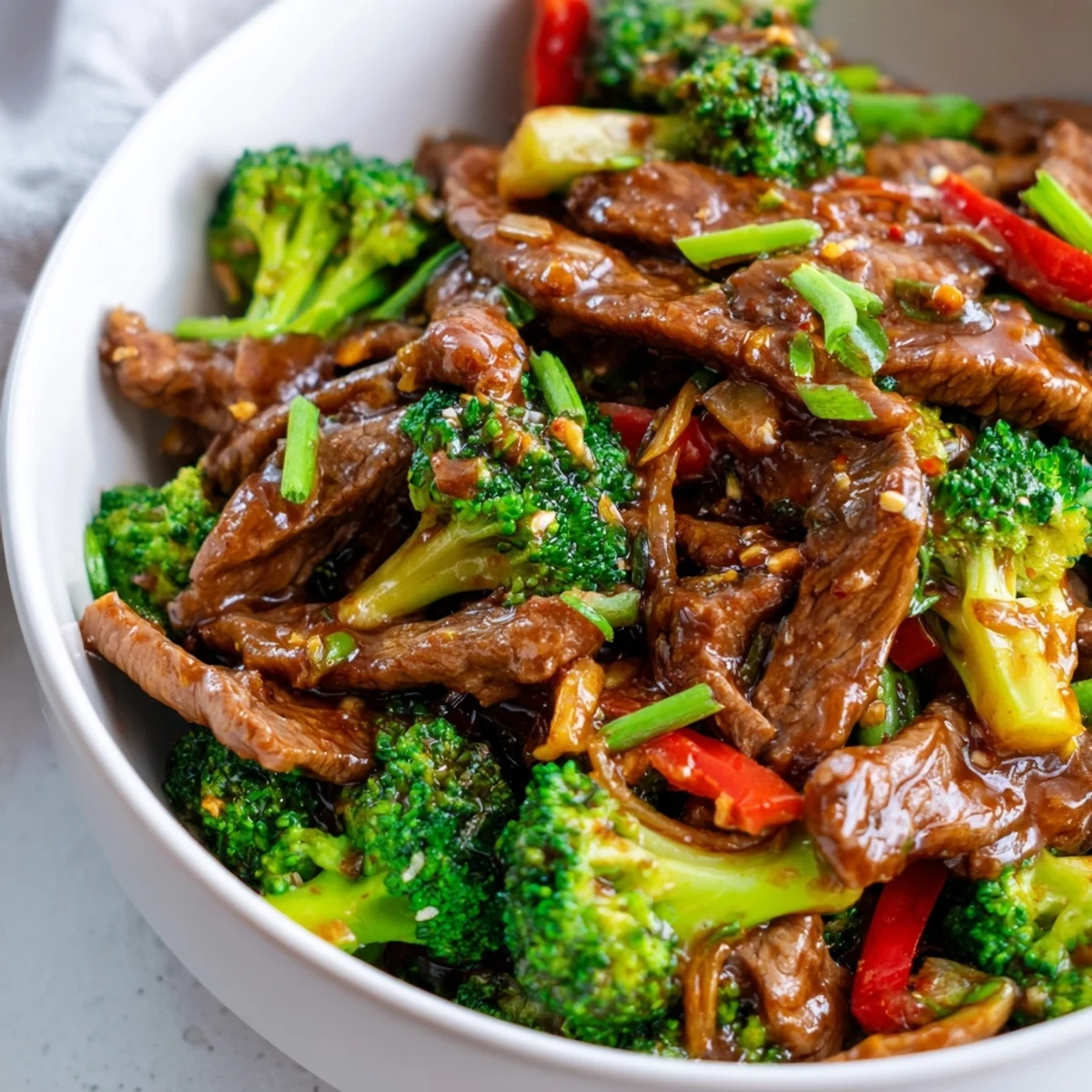 A wok-tossed skillet of freshly cooked Spicy Beef Stir Fry with Broccoli showcases succulent beef and crunchy vegetables coated in a glossy, chili-infused sauce, perfect for a quick weeknight dinner.