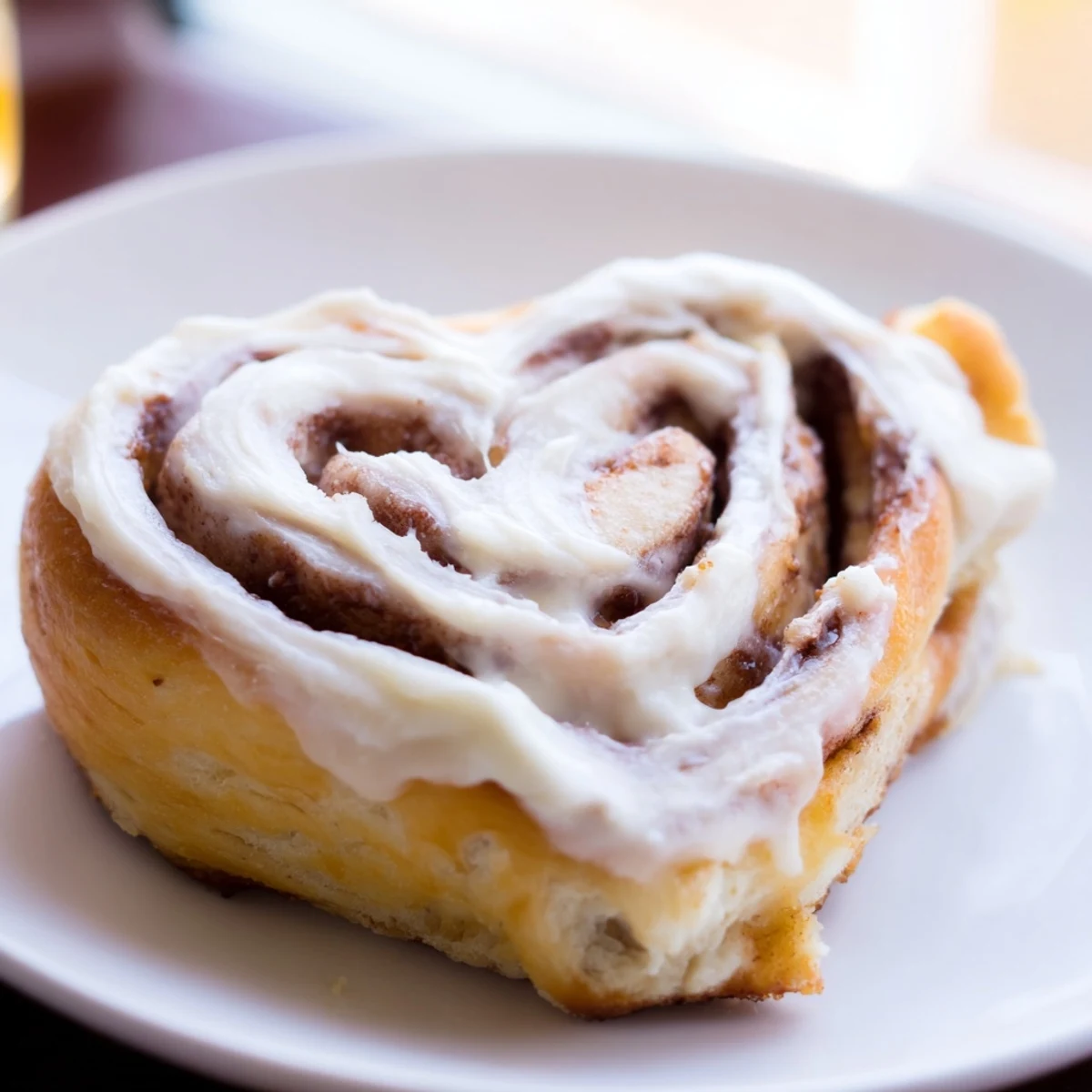 Soft, heart-shaped Sweetheart Cinnamon Rolls topped with thick cream cheese icing, ready for a romantic Valentine's Day breakfast or brunch.