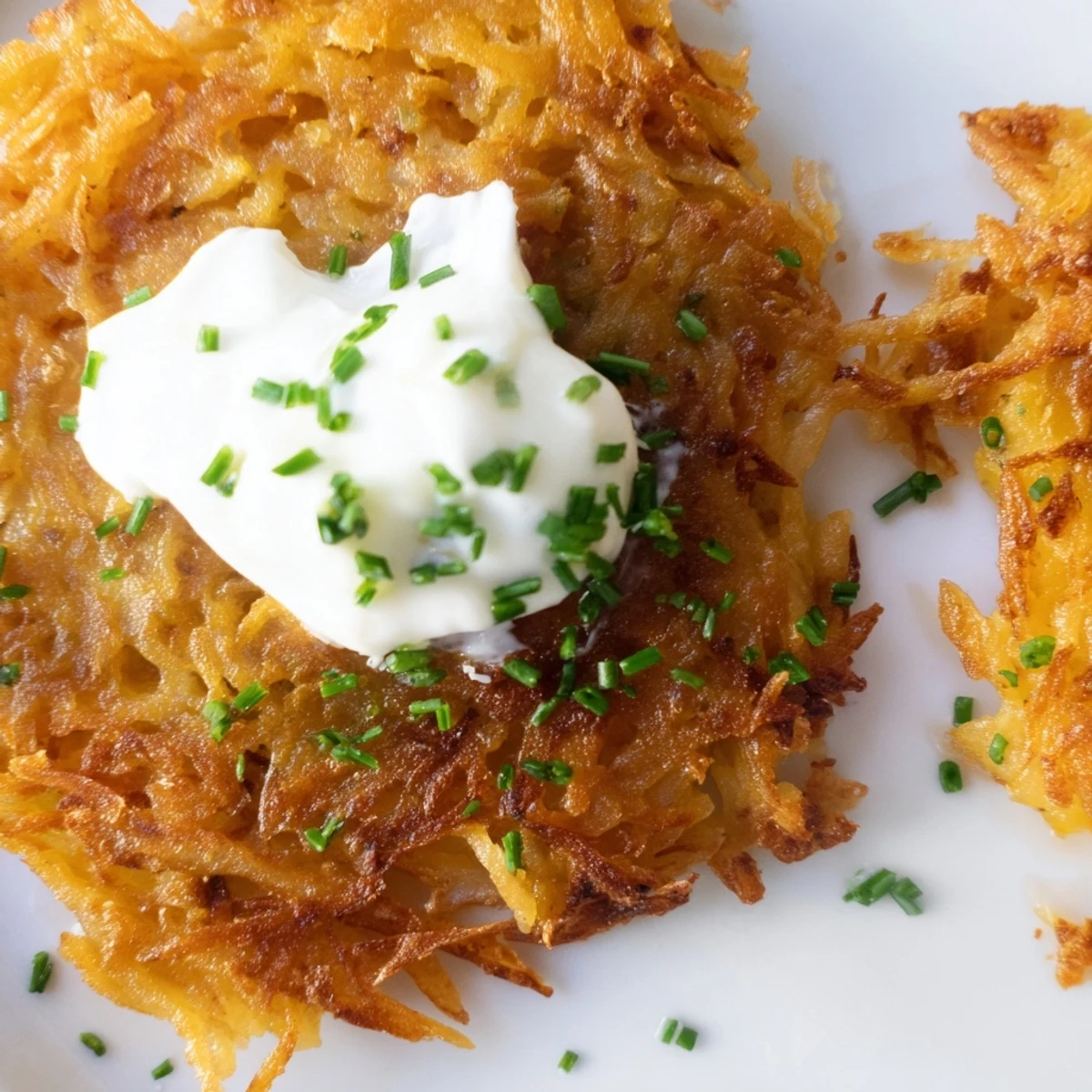 Hearty Irish Boxty Potato Pancakes served hot with sour cream, perfect for a savory breakfast or brunch plate.