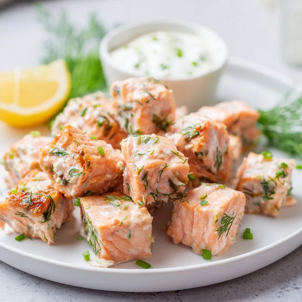 A close-up of tender baked salmon snack bites, glistening with lemon zest, ready to enjoy as a healthy appetizer.