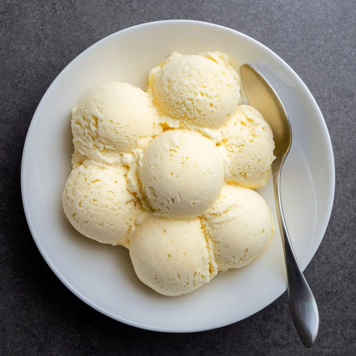 Homemade Creamy Treat Ice Cream in a rustic bowl, garnished with a vintage spoon for serving.  