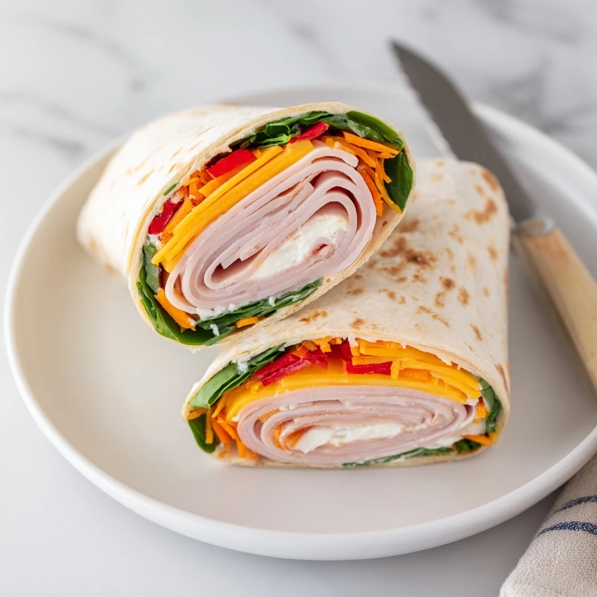 Fresh Turkey Snack Wrap Rolls with creamy cheese, deli turkey, and crisp vegetables, served as a quick, high-protein lunch.
