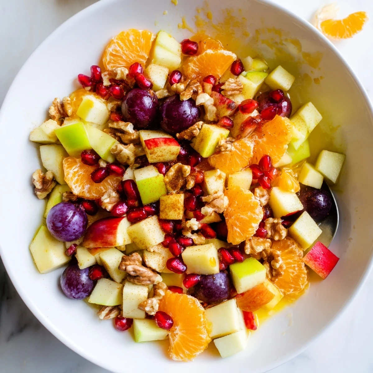 A vibrant bowl of Winter Snack Fruit Mix with diced apples, pears, and jewel-toned pomegranate seeds.