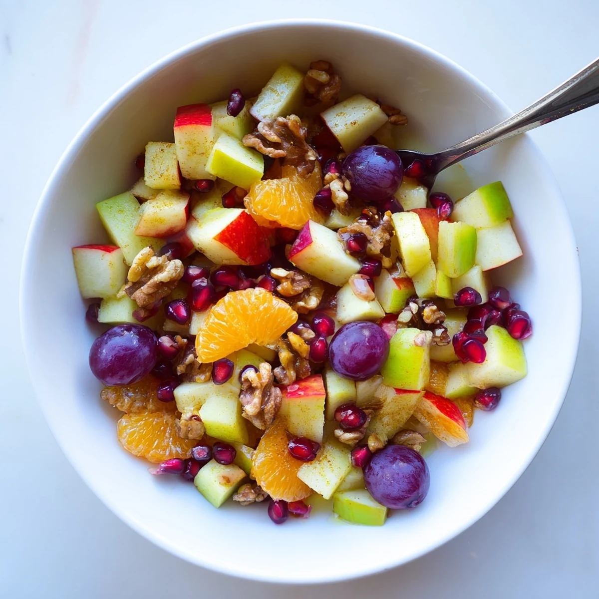 Close-up of Winter Snack Fruit Mix topped with walnuts and juicy grapes, perfect for a healthy snack.