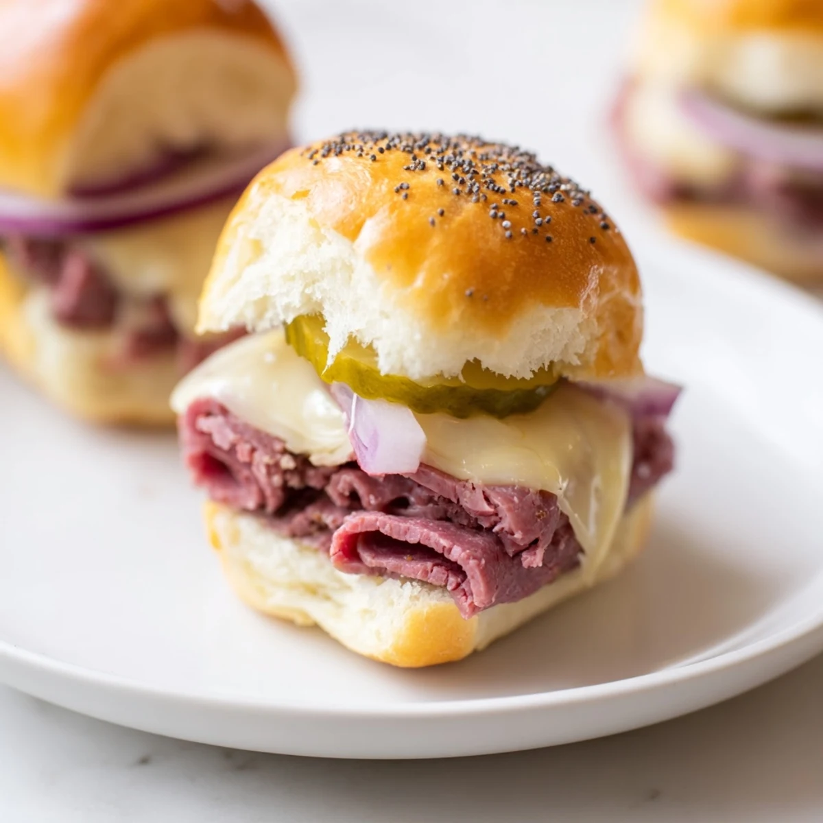 Hearty Corned Beef Sliders with tangy mustard and pickles on soft buns, ready to serve warm.