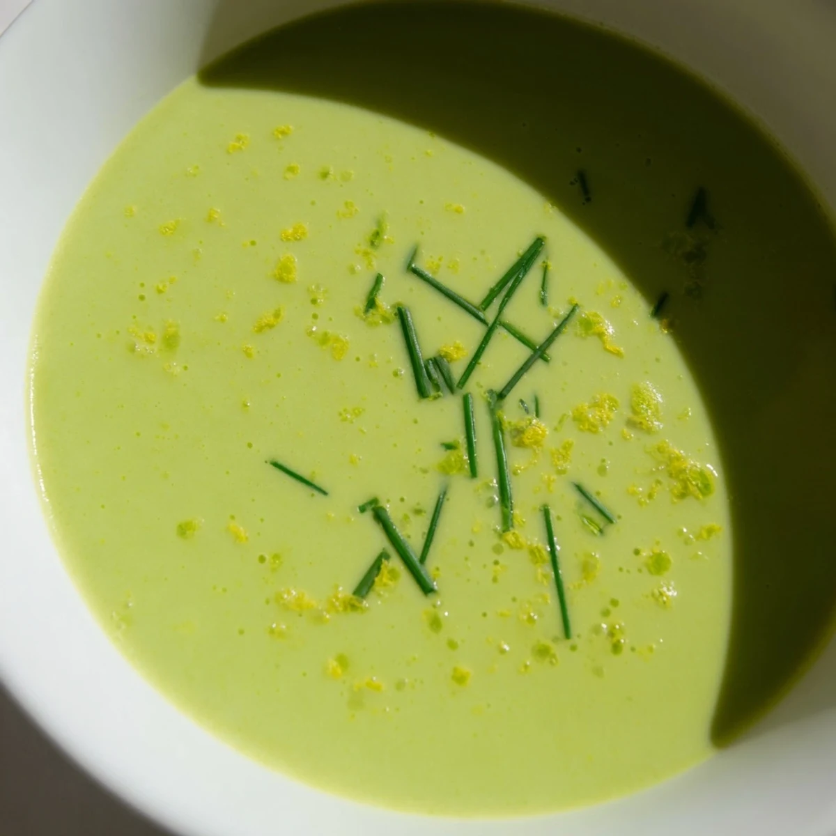 Freshly blended Creamy Asparagus Soup with Lemon served hot, highlighting its vibrant green color and velvety texture.