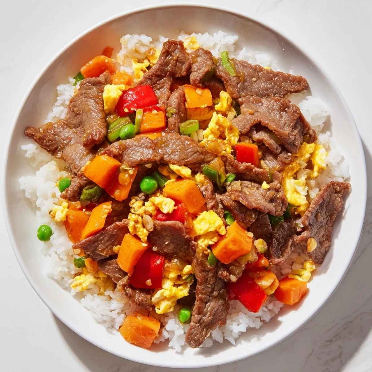 Close-up of Beef Fried Rice with Vegetables highlighting crisp carrots, peas, and savory beef.