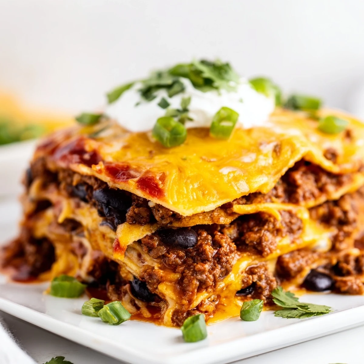 Layers of seasoned ground beef, tortillas, and zesty red enchilada sauce baked with melted cheddar and Monterey Jack cheeses.