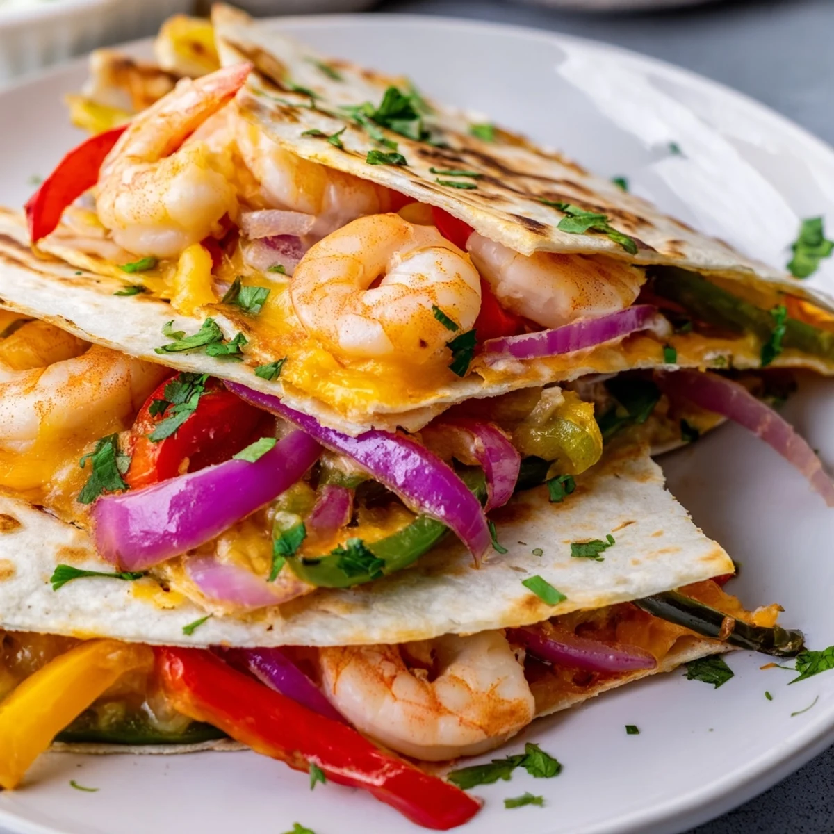 Golden-baked Shrimp Fajita Sheet Pan Quesadillas loaded with sautéed peppers and onions.