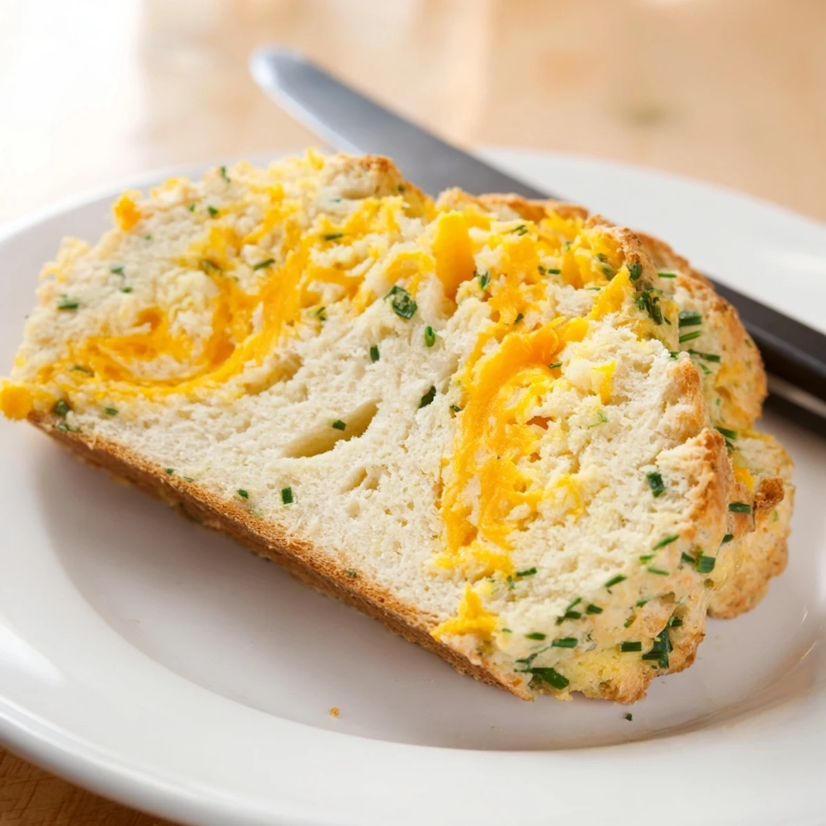 Just out of the oven, this Savory Cheddar & Chive Irish Soda Bread has a crisp crust and inviting cheesy aroma.
