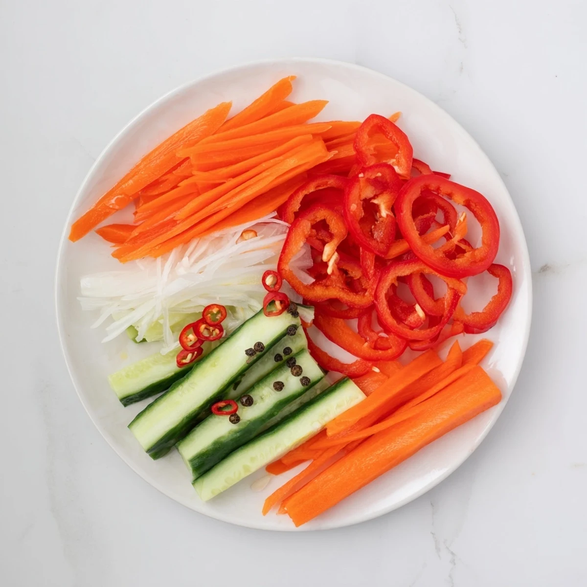 A top-down view of Vietnamese Vegetable Pickle Medley on a banh mi sandwich with layers of crunchy pickled veggies.