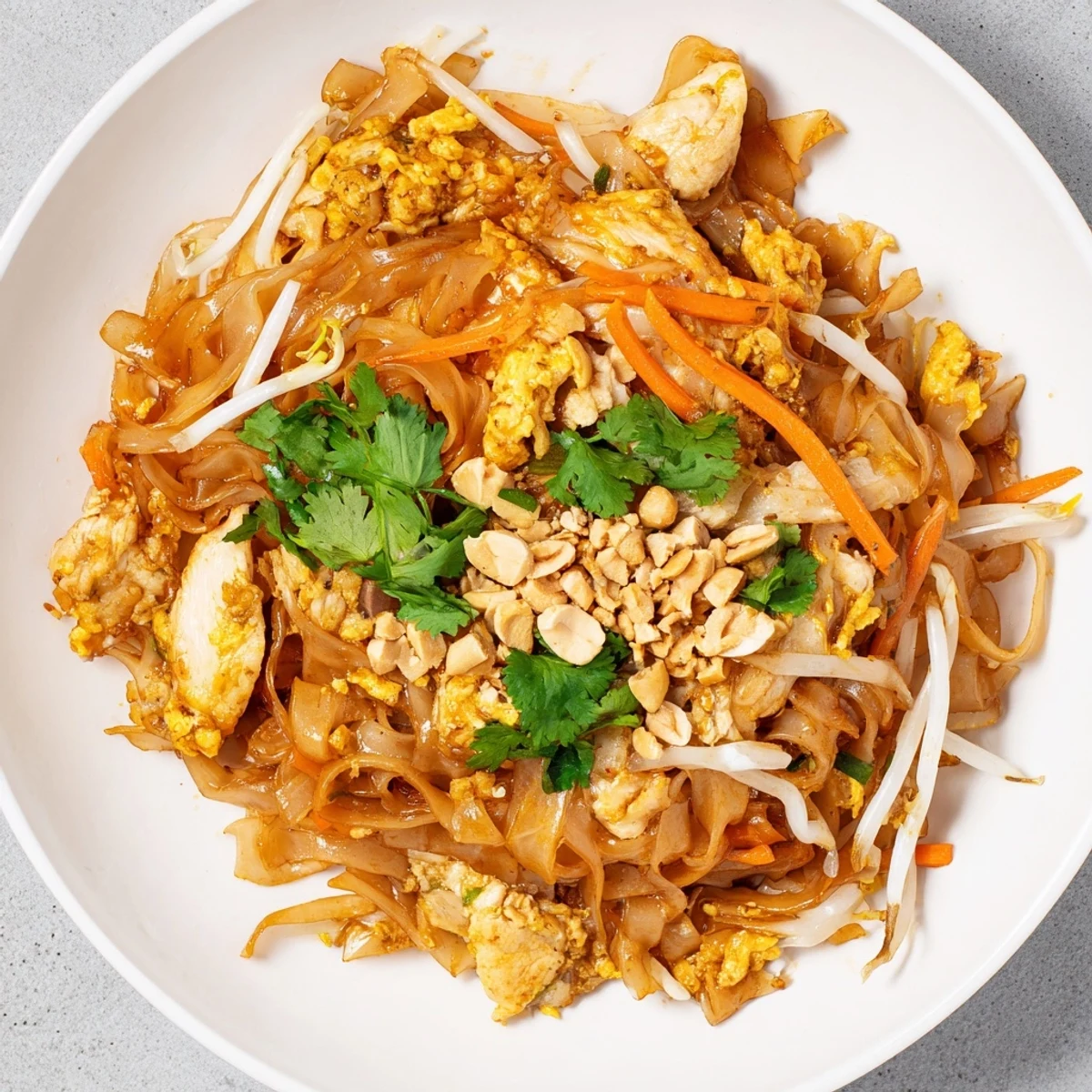 Vibrant Chicken Pad Thai featuring tender rice noodles coated in tangy tamarind sauce