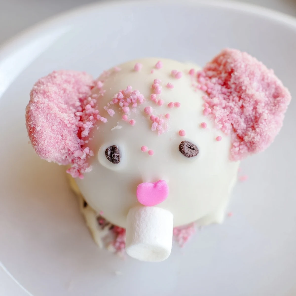 White chocolate covered Bunny Oreo balls decorated with mini marshmallow ears, heart sprinkles, and fluffy tails.