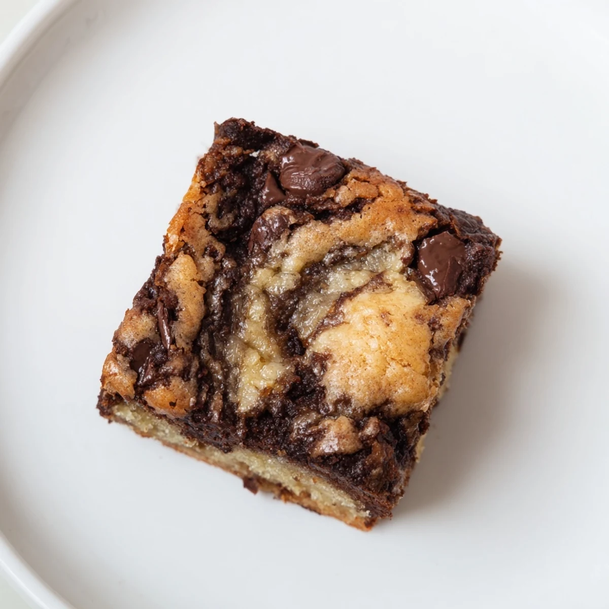 Decadent marbled banana bread brownie bars fresh from the oven with chocolate swirls