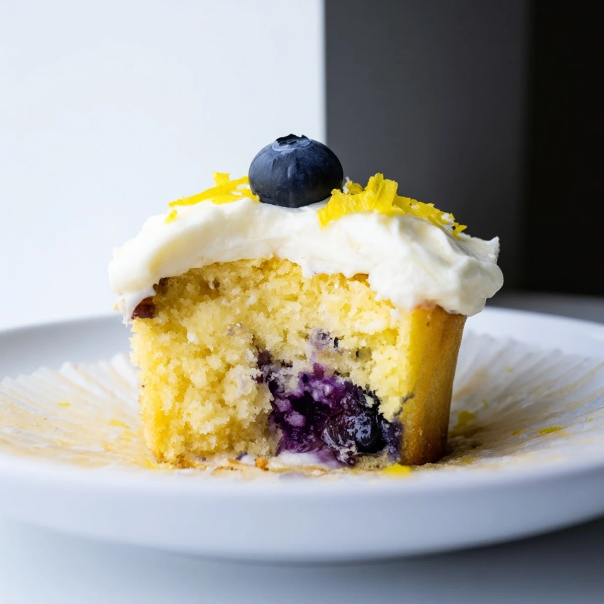 Light and airy lemon blueberry cupcakes swirled with zesty cream cheese frosting
