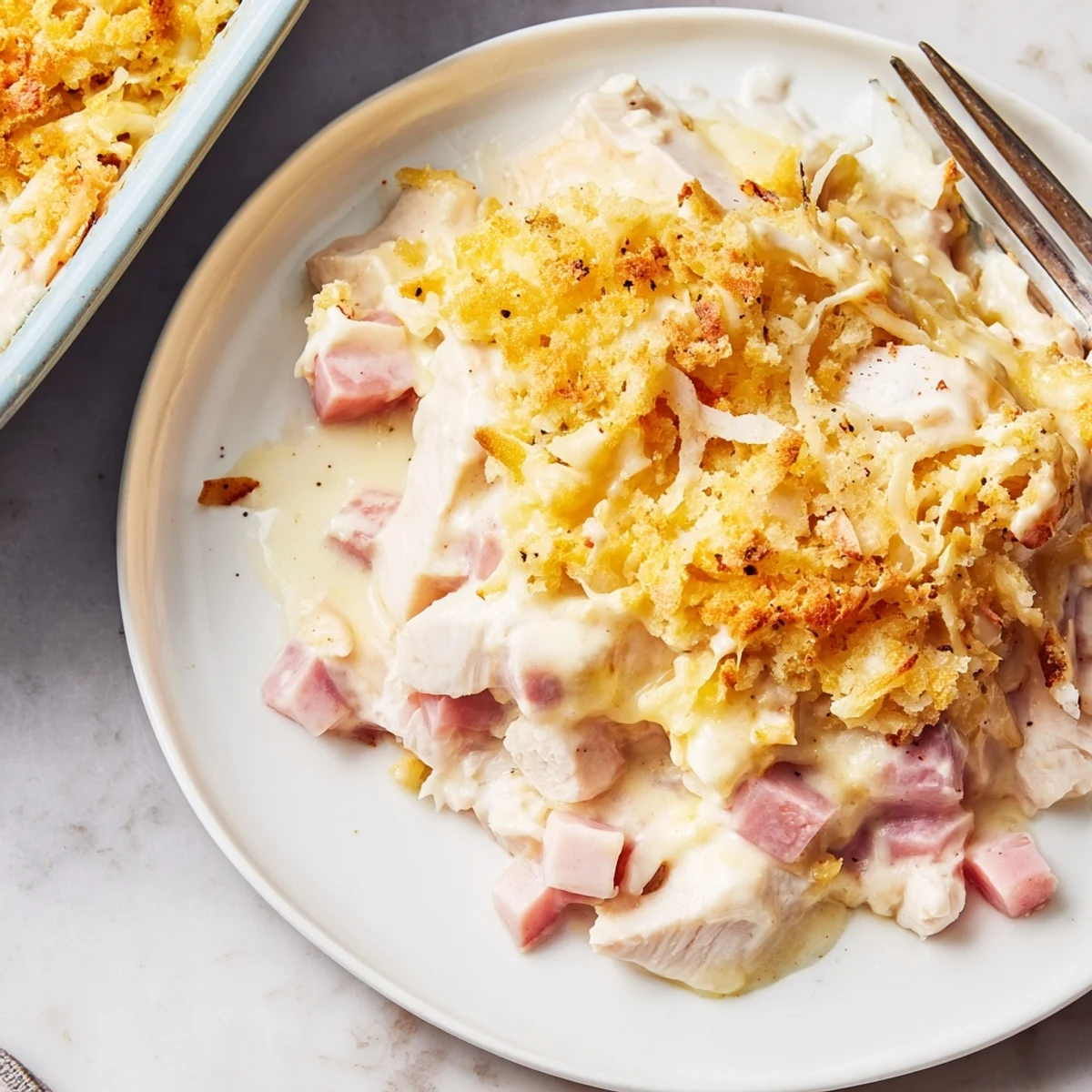 Warm Chicken Cordon Bleu Casserole Recipe sliced, tender chicken and ham under melted Swiss