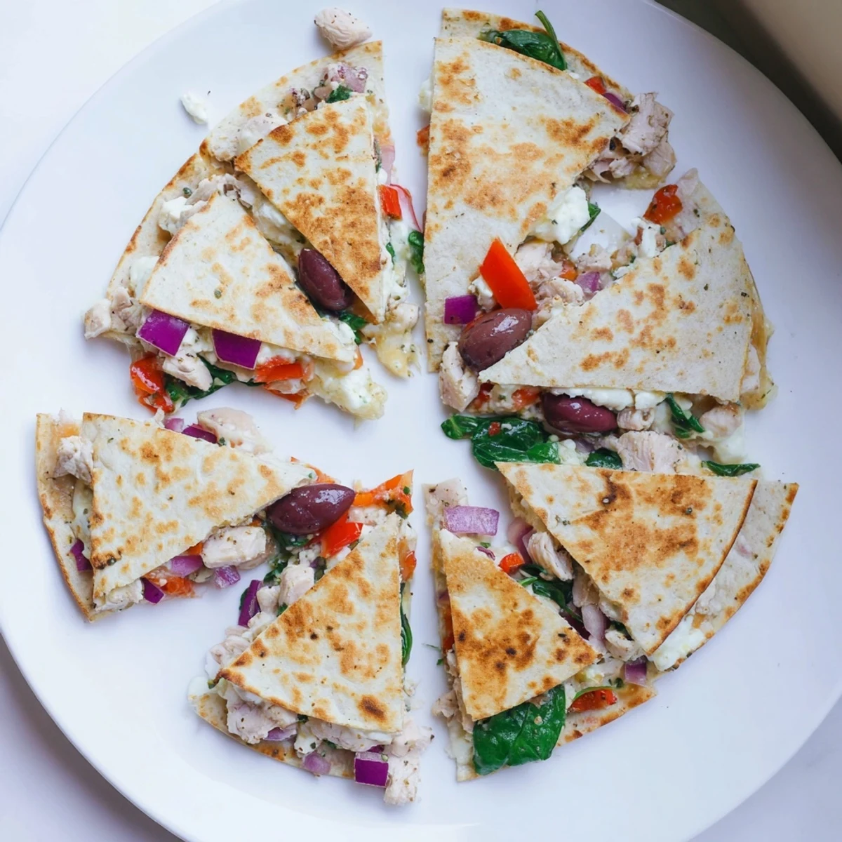 Crispy flour tortilla folded around juicy marinated Greek chicken with roasted red peppers and Kalamata olives
