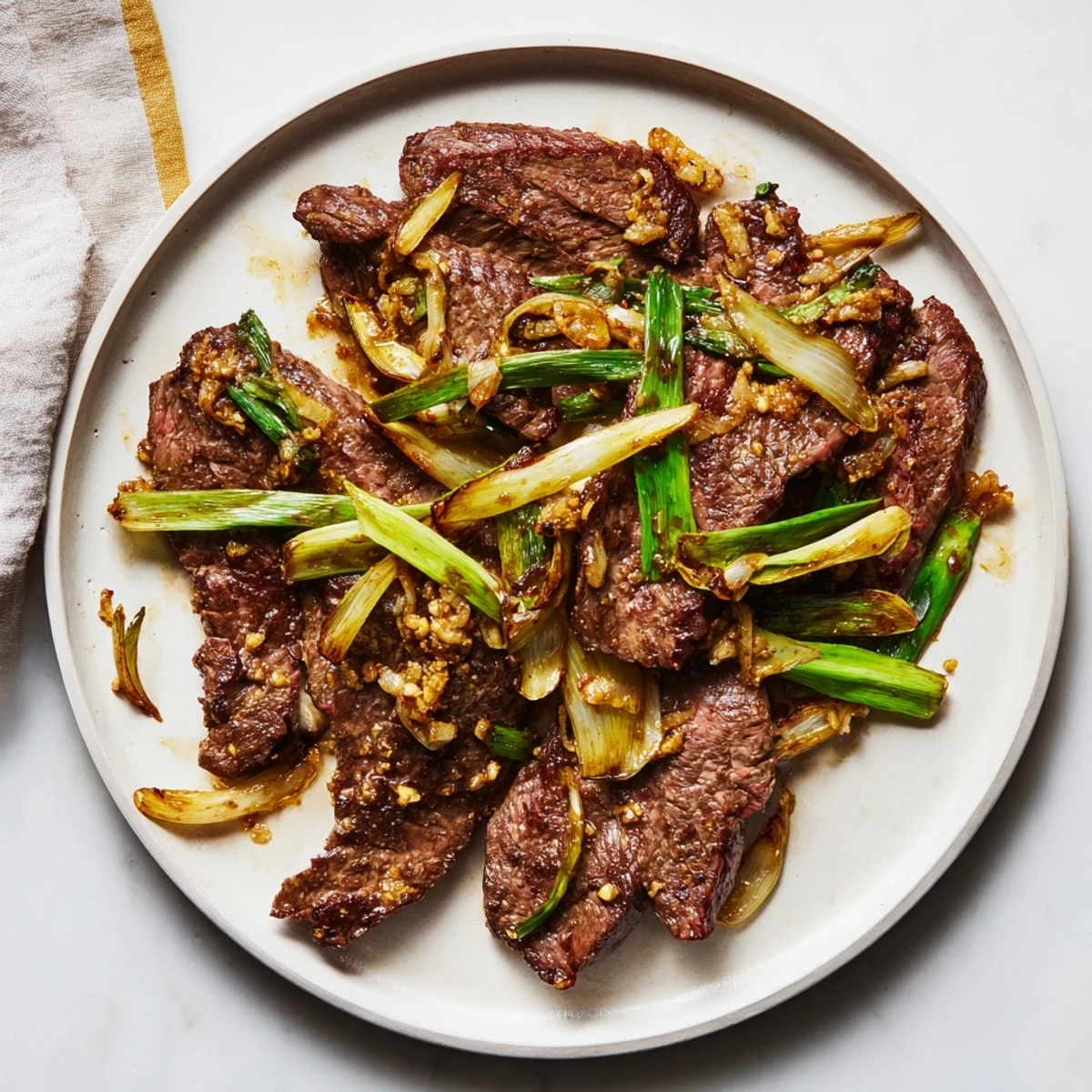 Tender marinated beef and sweet onions tossed in rich brown sauce over white rice