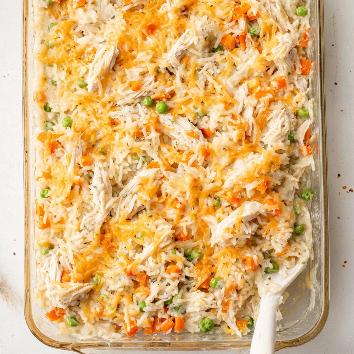 Homemade chicken and rice casserole bake featuring tender meat pieces in a rich cheese sauce.