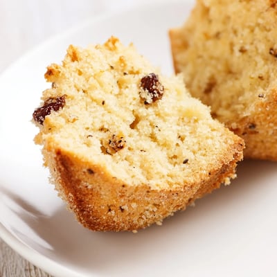 A close-up of Mini Irish Soda Bread Muffins revealing the moist interior and sprinkle of caraway seeds for flavor.