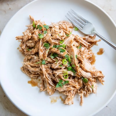 Family style Slow Cooker Brown Sugar Garlic Chicken served hot with chopped parsley.